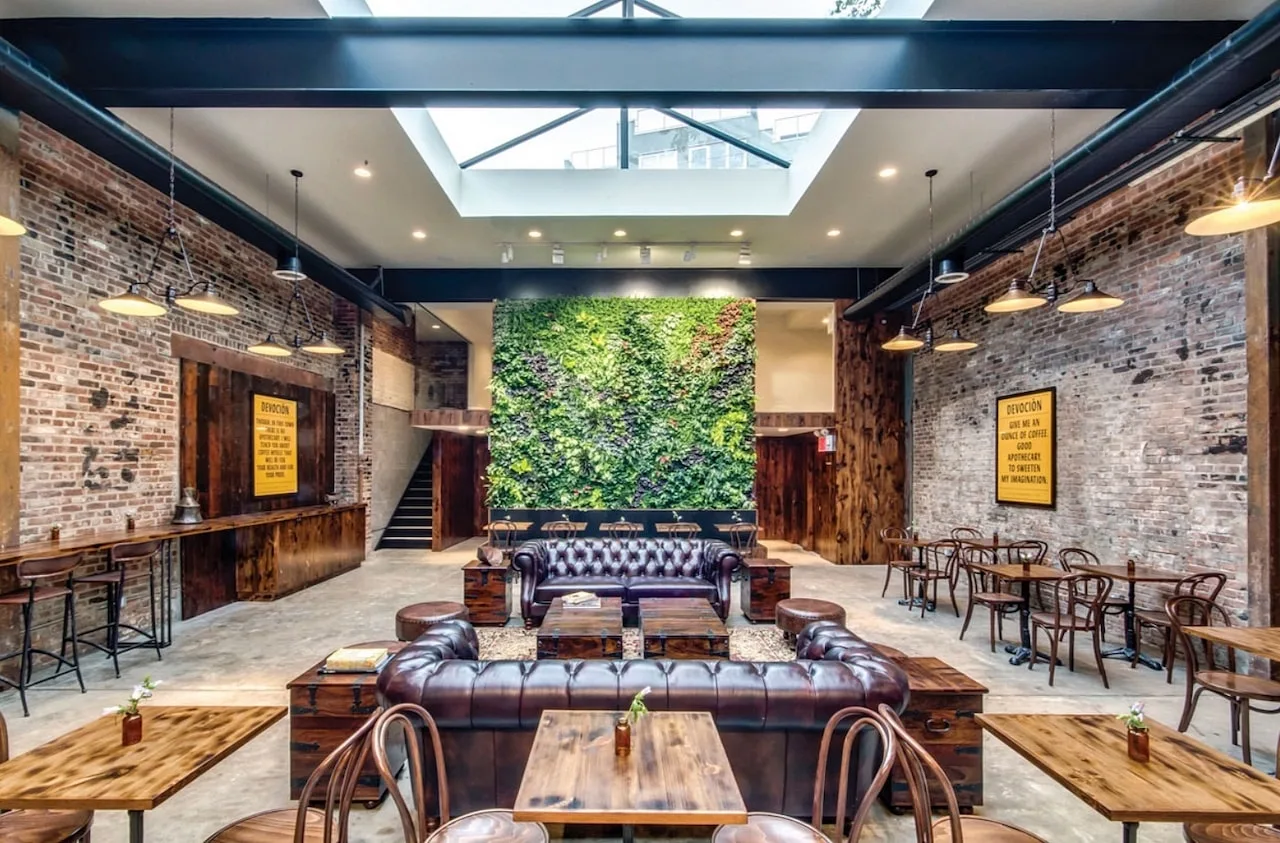 11 Aesthetic Coffee Shop Decor Ideas That'll Keep Customers Coming Back 14 coffee shop decor ideas skylight plant wall