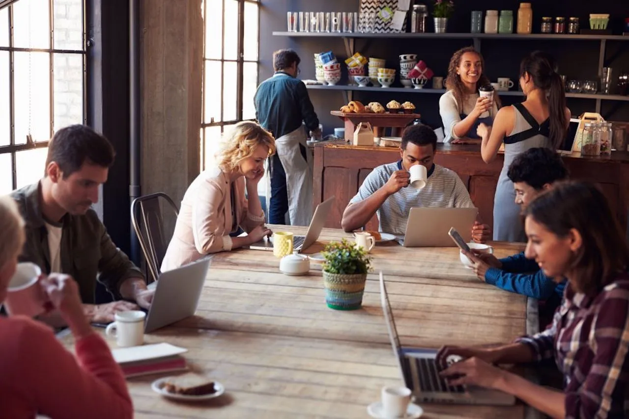 11 Aesthetic Coffee Shop Decor Ideas That'll Keep Customers Coming Back 12 coffee shop decor ideas workers communal table