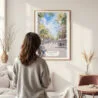 Framed Barcelona Watercolor Wall Art - In Living Room with Woman Looking at it - Portrait