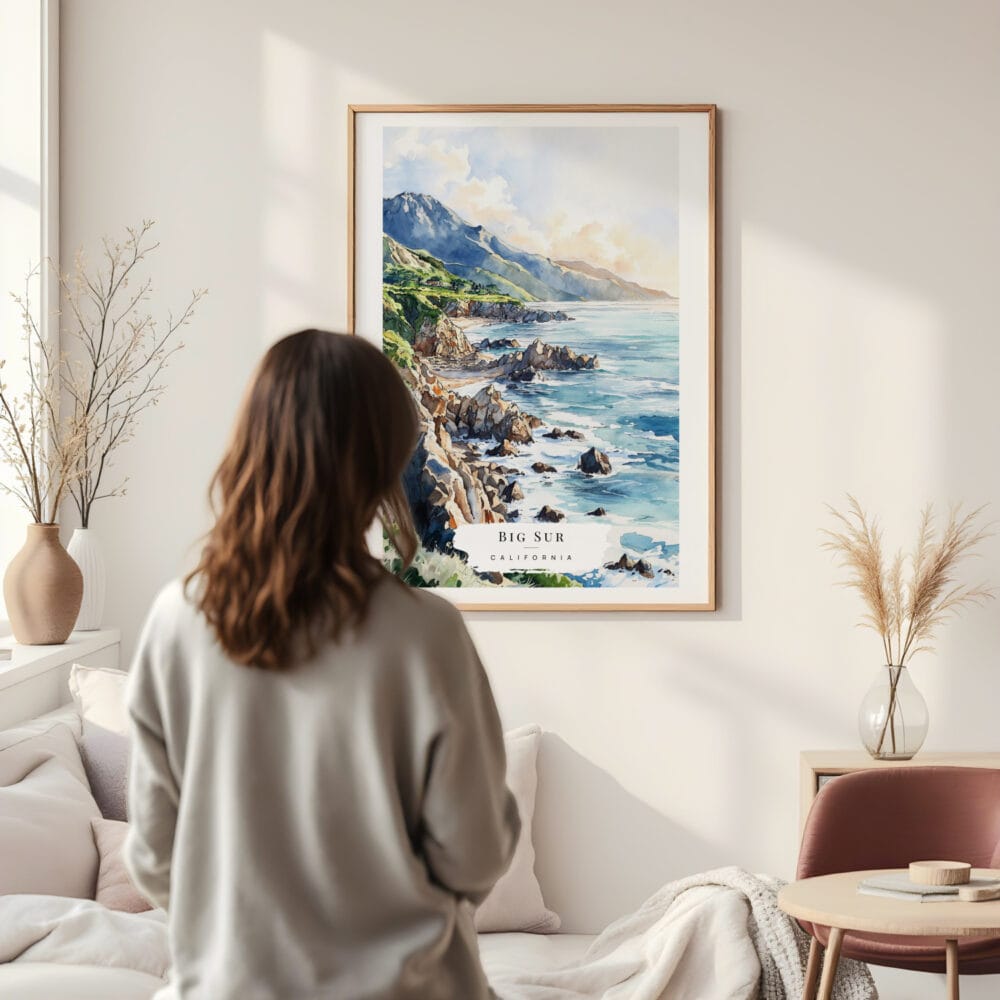 Framed Big Sur Watercolor Wall Art - In Living Room with Woman Looking at it - Portrait Framed Big Sur Watercolor Wall Art - In Living Room with Woman Looking at it - Portrait