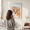 Framed Bryce Canyon National Park Watercolor Wall Art - In Living Room with Woman Looking at it - Portrait