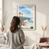 Framed California Laguna Beach Watercolor Wall Art - In Living Room with Woman Looking at it - Portrait