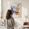Framed Canadian Rocky Mountains Watercolor Wall Art - In Living Room with Woman Looking at it - Portrait