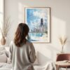 Framed Chicago Skyline Watercolor Wall Art - In Living Room with Woman Looking at it - Portrait