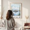 Framed Crater Lake National Park Watercolor Wall Art - In Living Room with Woman Looking at it - Portrait