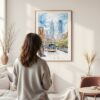 Framed Downtown Philadelphia Watercolor Wall Art - In Living Room with Woman Looking at it - Portrait