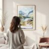 Framed Glacier National Park Watercolor Wall Art - In Living Room with Woman Looking at it - Portrait