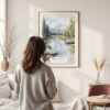 Framed Grand Teton National Park Watercolor Wall Art - In Living Room with Woman Looking at it - Portrait