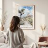 Framed Joshua Tree National Park Watercolor Wall Art - In Living Room with Woman Looking at it - Portrait