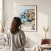 Framed Lagos Portugal Cliffs Watercolor Wall Art - In Living Room with Woman Looking at it - Portrait