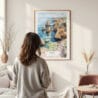 Framed Lagos Portugal Cliffs Watercolor Wall Art - In Living Room with Woman Looking at it - Portrait