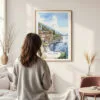 Framed Lake Como Watercolor Wall Art - In Living Room with Woman Looking at it - Portrait
