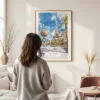 Framed Las Vegas Watercolor Wall Art - In Living Room with Woman Looking at it - Portrait
