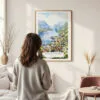 Framed Norwegian Fjords Watercolor Wall Art - In Living Room with Woman Looking at it - Portrait