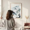 Framed Pacific Northwest Watercolor Wall Art - In Living Room with Woman Looking at it - Portrait