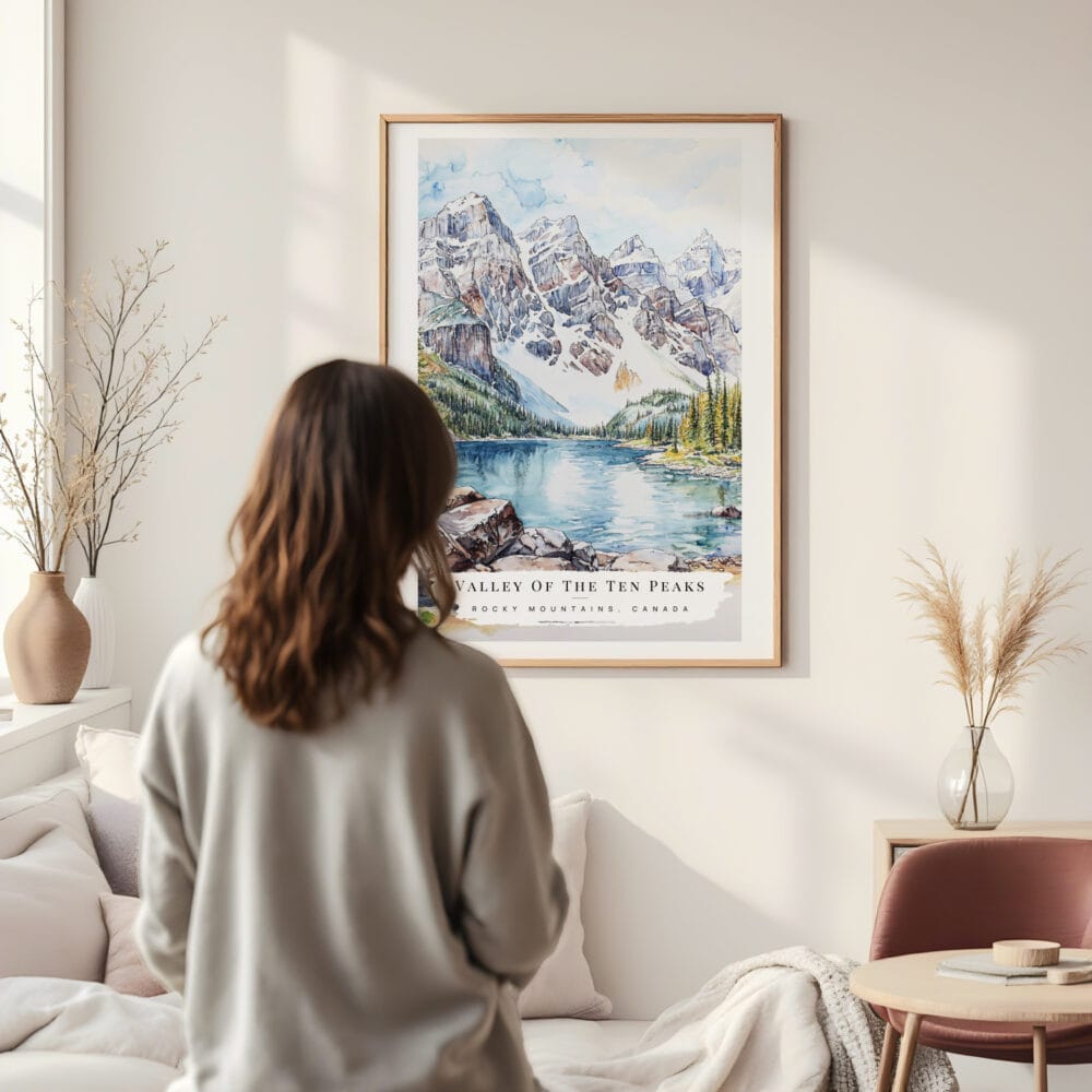 Framed Rocky Mountains Valleys Of the Ten Peaks Watercolor Wall Art - In Living Room with Woman Looking at it - Portrait Framed Rocky Mountains Valleys Of the Ten Peaks Watercolor Wall Art - In Living Room with Woman Looking at it - Portrait