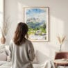 Framed Rocky Mountains Watercolor Wall Art - In Living Room with Woman Looking at it - Portrait