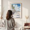 Framed Santa Monica Watercolor Wall Art - In Living Room with Woman Looking at it - Portrait