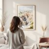 Framed Badlands National Park Watercolor Wall Art - In Living Room with Woman Looking at it - Portrait