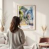 Framed Batu Caves Watercolor Wall Art - In Living Room with Woman Looking at it - Portrait
