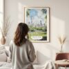 Framed Central Park New York Watercolor Wall Art - In Living Room with Woman Looking at it - Portrait