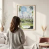 Framed Central Park New York Watercolor Wall Art - In Living Room with Woman Looking at it - Portrait