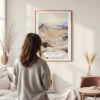 Framed Death Valley Watercolor Wall Art - In Living Room with Woman Looking at it - Portrait