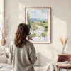 Framed Napa Valley Watercolor Wall Art - In Living Room with Woman Looking at it - Portrait