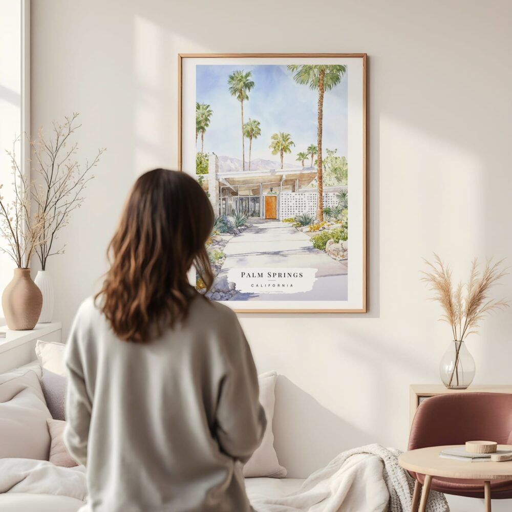 Framed Palm Springs California Watercolor Wall Art - In Living Room with Woman Looking at it - Portrait Framed Palm Springs California Watercolor Wall Art - In Living Room with Woman Looking at it - Portrait