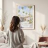 Framed Palm Springs California Watercolor Wall Art - In Living Room with Woman Looking at it - Portrait