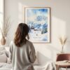Framed Skiing in Grindelwald Watercolor Wall Art - In Living Room with Woman Looking at it - Portrait