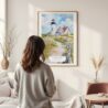 Framed Cape Cod Nobska Lighthouse Watercolor Wall Art - In Living Room with Woman Looking at it - Portrait