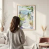 Framed Cape Cod Provincetown Watercolor Wall Art - In Living Room with Woman Looking at it - Portrait