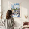 Framed Cape Cod Watercolor Wall Art - In Living Room with Woman Looking at it - Portrait