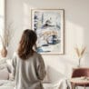 Framed Fairbanks Alaska Winter Watercolor Wall Art - In Living Room with Woman Looking at it - Portrait