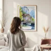 Framed Lauterbrunnen Switzerland Watercolor Wall Art - In Living Room with Woman Looking at it - Portrait