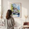 Framed Lauterbrunnen Switzerland Watercolor Wall Art - In Living Room with Woman Looking at it - Portrait