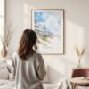 Framed Outer Banks Cottage Watercolor Wall Art - In Living Room with Woman Looking at it - Portrait