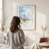 Framed Outer Banks Cottage Watercolor Wall Art - In Living Room with Woman Looking at it - Portrait