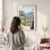 Framed Wengen Switzerland Watercolor Wall Art - In Living Room with Woman Looking at it - Portrait