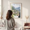 Framed Wengen Switzerland Watercolor Wall Art - In Living Room with Woman Looking at it - Portrait