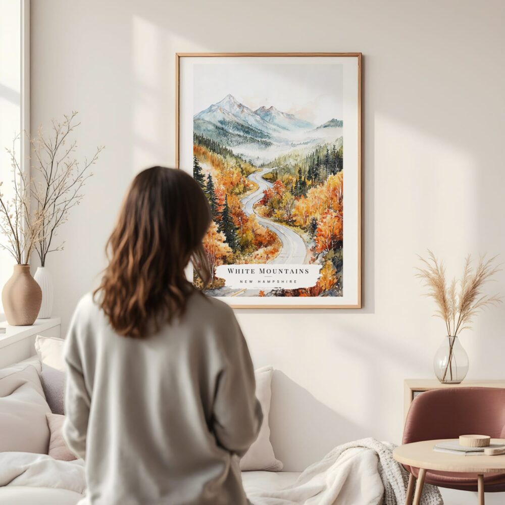 Framed White Mountains New Hampshire Watercolor Wall Art - In Living Room with Woman Looking at it - Portrait Framed White Mountains New Hampshire Watercolor Wall Art - In Living Room with Woman Looking at it - Portrait