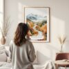 Framed White Mountains New Hampshire Watercolor Wall Art - In Living Room with Woman Looking at it - Portrait