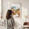 Framed White Mountains New Hampshire Watercolor Wall Art - In Living Room with Woman Looking at it - Portrait