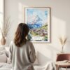 Framed Zermatt Watercolor Wall Art - In Living Room with Woman Looking at it - Portrait