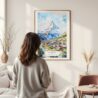 Framed Zermatt Watercolor Wall Art - In Living Room with Woman Looking at it - Portrait
