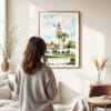 03 - Framed Balboa Park California Tower Watercolor Wall Art - In Living Room with Woman Looking at it - Portrait