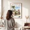 03 - Framed Balboa Park Watercolor Wall Art - In Living Room with Woman Looking at it - Portrait