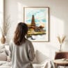 03 - Framed Bali Temple Watercolor Wall Art - In Living Room with Woman Looking at it - Portrait