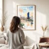 03 - Framed Brisbane Skyline Watercolor Wall Art - In Living Room with Woman Looking at it - Portrait